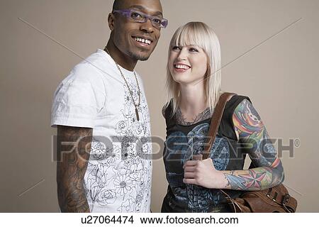 Portrait of young man and woman smiling View Large Photo Image Picture - Portrait of young man and woman smiling. Fotosearch