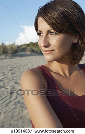 Portrait of young woman on beach looking away View Large Photo Image Stock Photo - Portrait of young woman on beach looking away. Fotosearch
