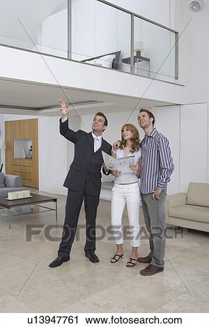 Real estate agent showing couple new home View Large Photo Image Stock Image - Real estate agent showing couple new home. Fotosearch