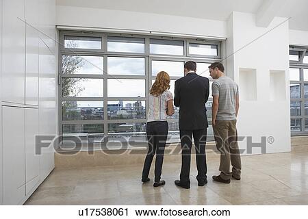 Real estate agent showing couple new apartment View Large Photo Image Stock Image - Real estate agent showing couple new apartment. Fotosearch