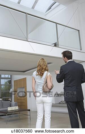 Real estate agent showing woman new home View Large Photo Image Stock Image - Real estate agent showing woman new home. Fotosearch