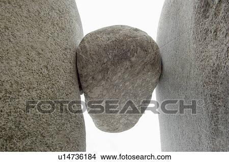 Rock wedged between two boulders View Large Photo Image Picture - Rock wedged between two boulders. Fotosearch