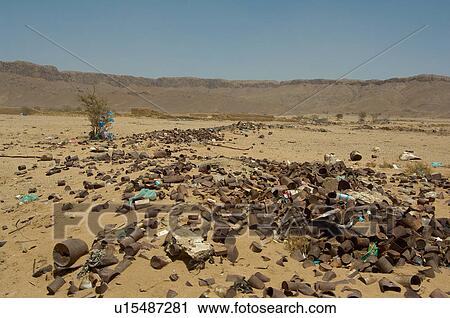 Stock Image - Rocks and garbage in the desert. Fotosearch