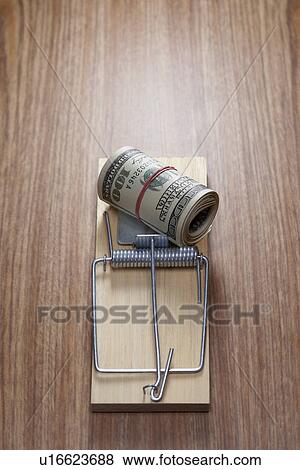 Stock Photo - Roll of dollar bills in mouse trap. Fotosearch
