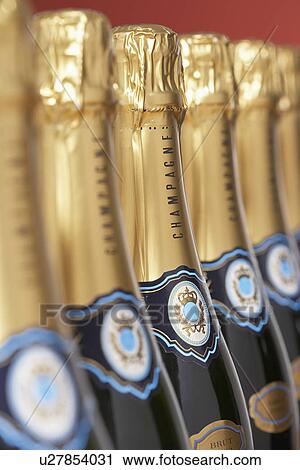 Stock Image - Row of champagne bottles close-up selective focus. Fotosearch