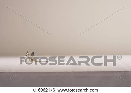 Salt and pepper shakers on table View Large Photo Image Stock Photograph - Salt and pepper shakers on table. Fotosearch
