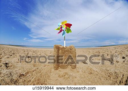 Sand castle with pinwheel on beach View Large Photo Image Picture - Sand castle with pinwheel on beach. Fotosearch
