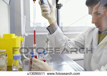 Scientist filling test tube with hi-tech pipette in laboratory View Large Photo Image Stock Image - Scientist filling test tube with hi-tech pipette in laboratory. Fotosearch