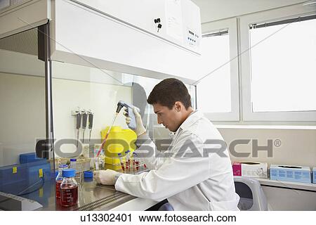 Scientist filling test tube with hi-tech pipette in laboratory View Large Photo Image Stock Image - Scientist filling test tube with hi-tech pipette in laboratory. Fotosearch