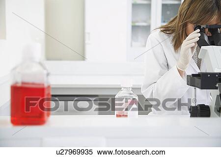 Scientist looking in microscope in laboratory View Large Photo Image Stock Photography - Scientist looking in microscope in laboratory. Fotosearch