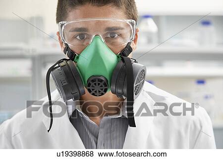 Stock Photo - Scientist wearing gas mask in laboratory. Fotosearch