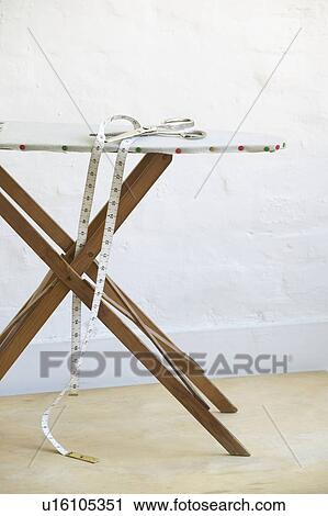 Scissors and measuring tape on ironing board View Large Photo Image Stock Image - Scissors and measuring tape on ironing board. Fotosearch