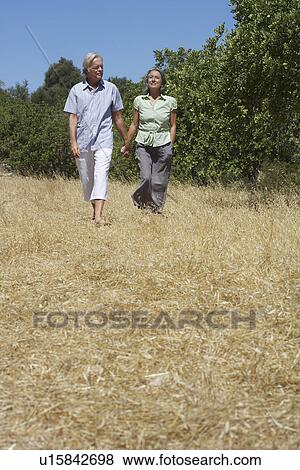 Senior couple on walk holding hands View Large Photo Image Stock Photo - Senior couple on walk holding hands. Fotosearch