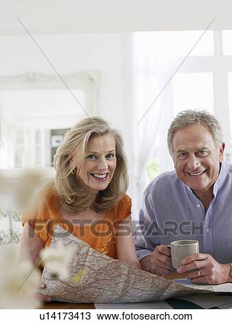 Senior couple sitting at dining table portrait View Large Photo Image Stock Image - Senior couple sitting at dining table portrait. Fotosearch