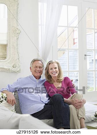 Senior couple sitting on sofa portrait View Large Photo Image Stock Photograph - Senior couple sitting on sofa portrait. Fotosearch