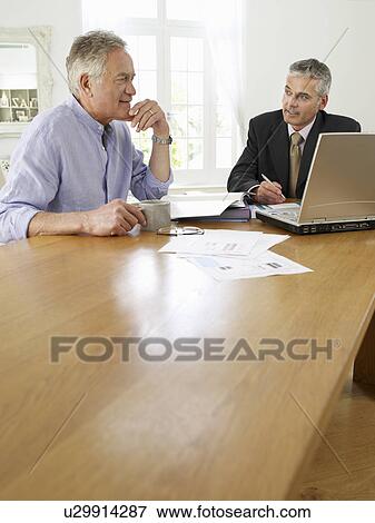 Senior man planning personal finance at home with finacial advisor View Large Photo Image Stock Photo - Senior man planning personal finance at home with finacial advisor. Fotosearch