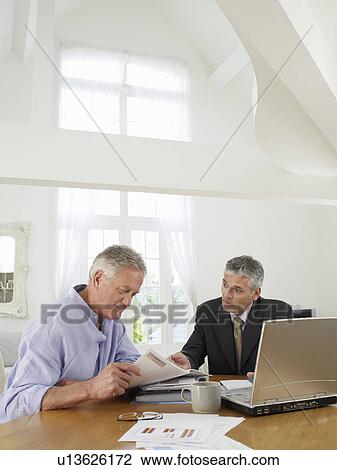 Senior man sitting at table with financial advisor View Large Photo Image Stock Image - Senior man sitting at table with financial advisor. Fotosearch