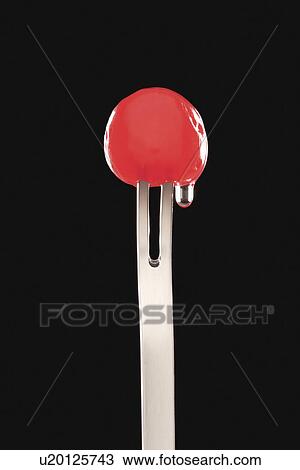Single cocktail cherry in fork black background View Large Photo Image Stock Image - Single cocktail cherry in fork black background. Fotosearch