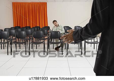 Single man listening to a seminar in conference room View Large Photo Image Stock Image - Single man listening to a seminar in conference room. Fotosearch