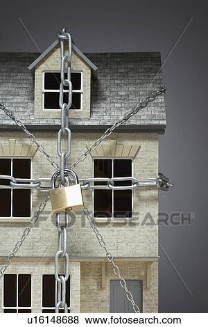 Small model of house chained View Large Photo Image Stock Photo - Small model of house chained. Fotosearch
