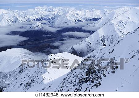 Snow-covered mountain range elevated view View Large Photo Image Stock Photograph - Snow-covered mountain range elevated view. Fotosearch