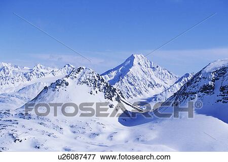 Snow-covered mountain range View Large Photo Image Stock Photo - Snow-covered mountain range. Fotosearch