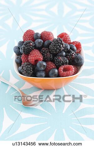 Stock Photograph - Spoon and bowl of forest fruits. Fotosearch