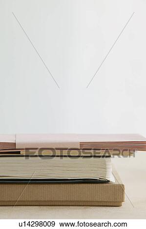 Stack of books and paper stationery studio shot View Large Photo Image Stock Photo - Stack of books and paper stationery studio shot. Fotosearch