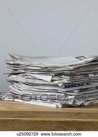 Stock Photo - Stack of newspapers on table. Fotosearch