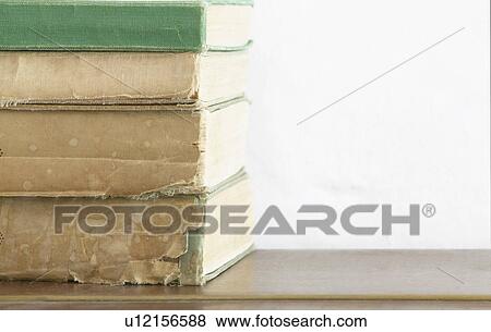 Stack of old books on wooden chest close up View Large Photo Image Stock Photo - Stack of old books on wooden chest close up. Fotosearch