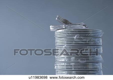 Stack of plates and cutlery wrapped in plastic View Large Photo Image Stock Photo - Stack of plates and cutlery wrapped in plastic. Fotosearch