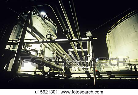 Stock Image - Storage tanks and pipes petrochemical oil refinery. Fotosearch