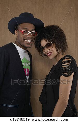 Studio portrait of young couple smiling View Large Photo Image Stock Photo - Studio portrait of young couple smiling. Fotosearch