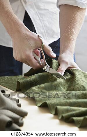 Tailor cutting fabric mid section close up View Large Photo Image Picture - Tailor cutting fabric mid section close up. Fotosearch