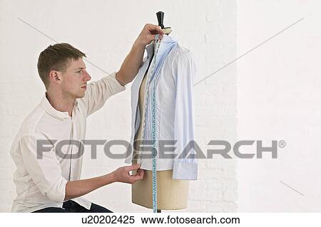 Tailor measuring blouse hanging on mannequin View Large Photo Image Stock Photography - Tailor measuring blouse hanging on mannequin. Fotosearch