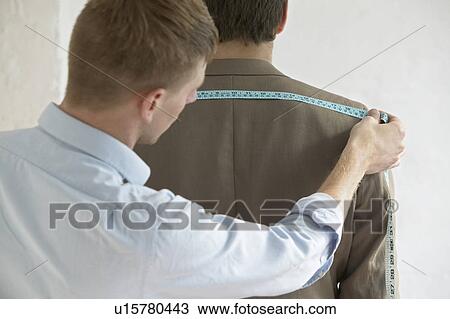 Tailor measuring jacket on man back view close up View Large Photo Image Stock Image - Tailor measuring jacket on man back view close up. Fotosearch