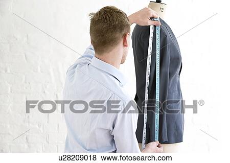 Tailor measuring jacket sleeve back view View Large Photo Image Stock Photo - Tailor measuring jacket sleeve back view. Fotosearch