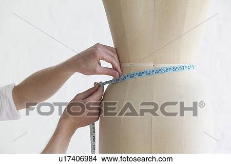 Tailor measuring mannequin close up of hands View Large Photo Image Picture - Tailor measuring mannequin close up of hands. Fotosearch