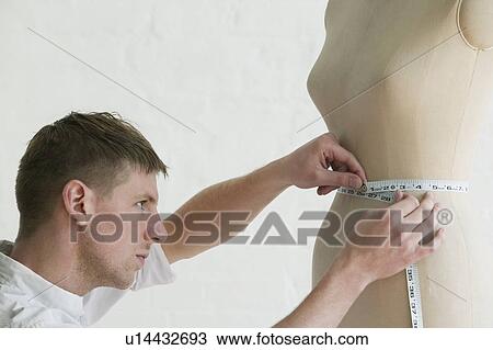 Tailor measuring mannequin side view close up View Large Photo Image Stock Image - Tailor measuring mannequin side view close up. Fotosearch