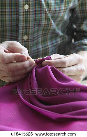 Tailor sewing fabric close up of hands mid section View Large Photo Image Stock Photograph - Tailor sewing fabric close up of hands mid section. Fotosearch