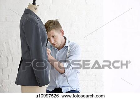 Tailor working on jacket in studio View Large Photo Image Stock Photograph - Tailor working on jacket in studio. Fotosearch