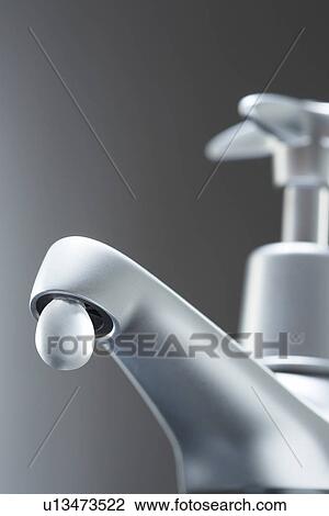 Stock Image - Tap with large drop of water. Fotosearch