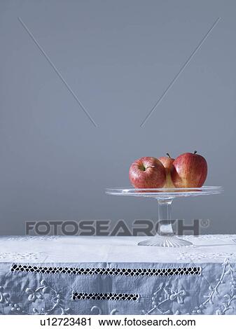 Three apples on fruit platter on table View Large Photo Image Stock Image - Three apples on fruit platter on table. Fotosearch