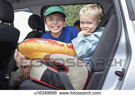 Three boys (3-11) in car portrait View Large Photo Image Stock Photo - Three boys (3-11) in car portrait. Fotosearch