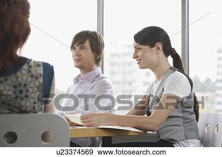 Three business colleugues at office meeting View Large Photo Image Stock Photo - Three business colleugues at office meeting. Fotosearch