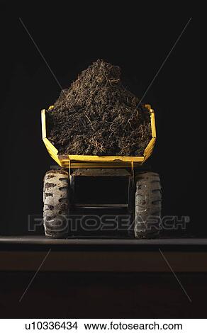 Toy dump truck with dirt back view View Large Photo Image Picture - Toy dump truck with dirt back view. Fotosearch