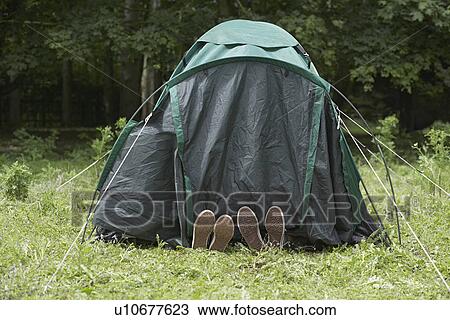 Two boys (7-9) lying in tent close-up of feet View Large Photo Image Stock Image - Two boys (7-9) lying in tent close-up of feet. Fotosearch