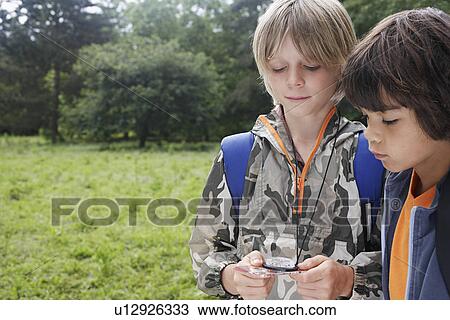 Two boys (7-9) using compass View Large Photo Image Stock Image - Two boys (7-9) using compass. Fotosearch