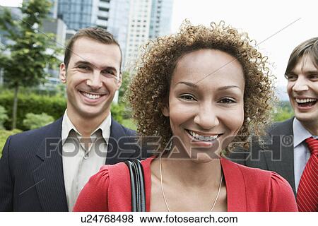 Stock Photo - Two business men and woman smiling outdoors portrait. Fotosearch