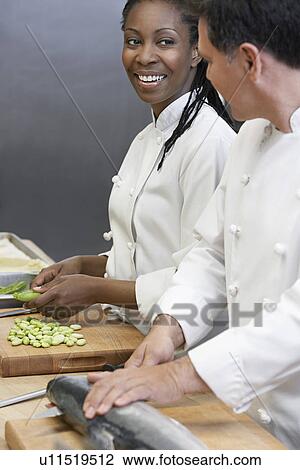 Two chefs preparing salmon and vegetables in kitchen View Large Photo Image Stock Image - Two chefs preparing salmon and vegetables in kitchen. Fotosearch